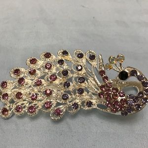 Pink and purple bejeweled peacock hair clip
